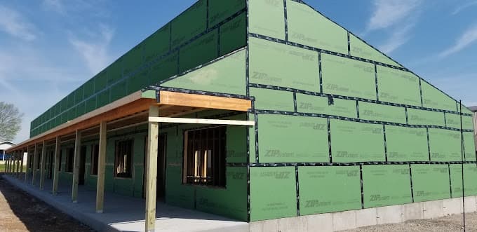 New single-story building framed and sheathed with a covered front porch